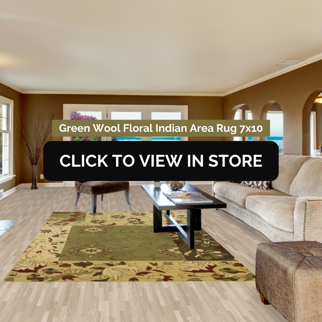 A cozy living room featuring a 7x10 Green Wool Floral Indian Area Rug with an intricate floral design in green and gold tones. The rug adds warmth and elegance to the space, complementing the beige sofa, dark wood coffee table, and natural light streaming through large windows.