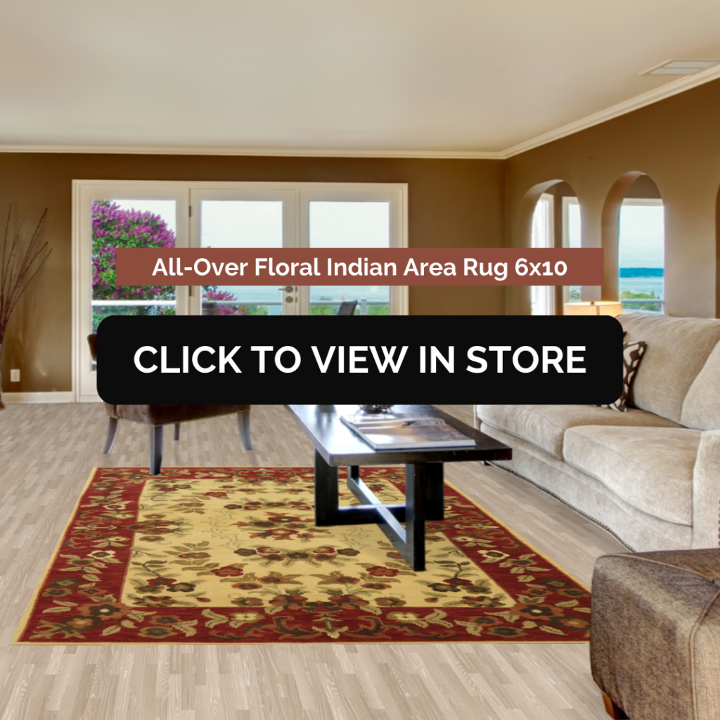 A cozy living room with a 6x10 All-Over Floral Indian Area Rug. The rug features a rich red and gold floral design that adds warmth and elegance to the room's neutral-toned furniture and wooden flooring.