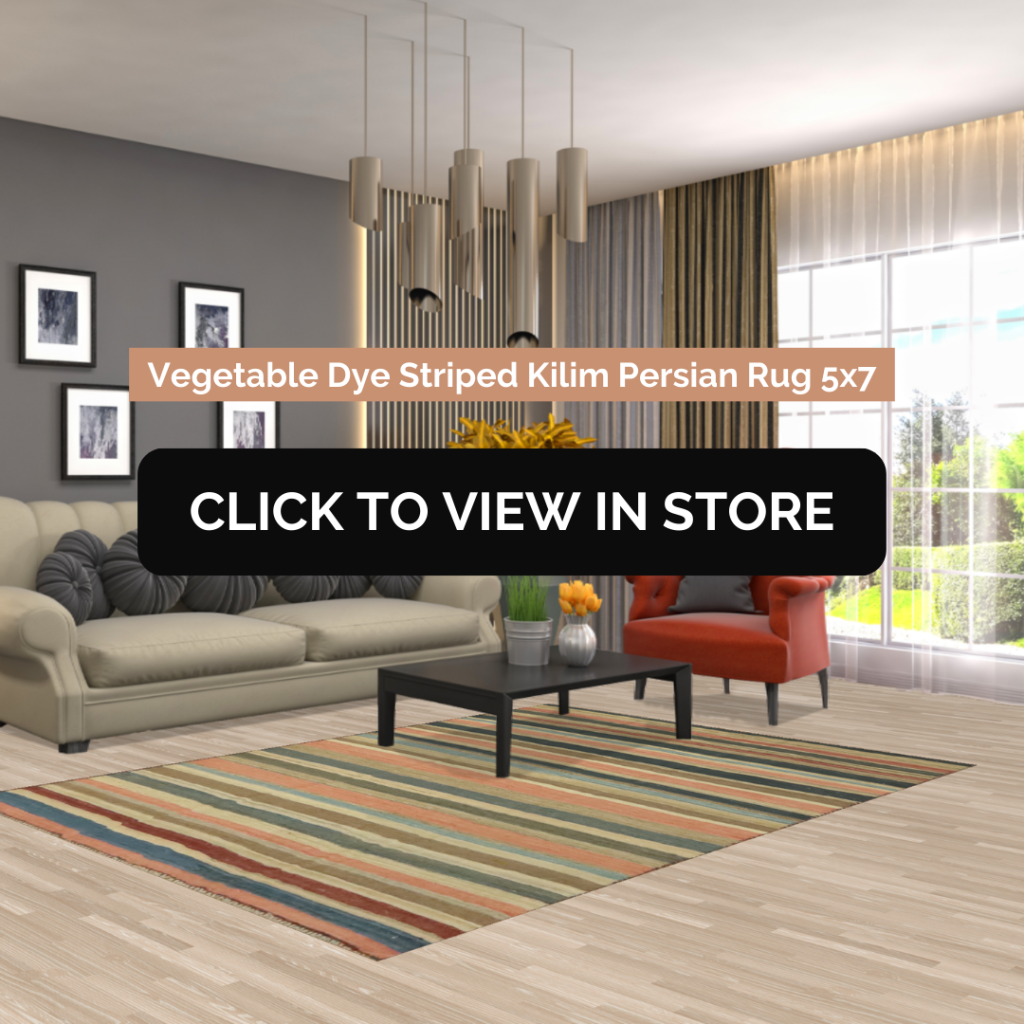Modern living room featuring a 5x7 Vegetable Dye Striped Kilim Persian rug. The rug adds a vibrant touch with its colorful striped pattern, complementing the neutral-toned sofa and bold red armchair. Floor-to-ceiling windows flood the space with natural light, enhancing the contemporary decor.