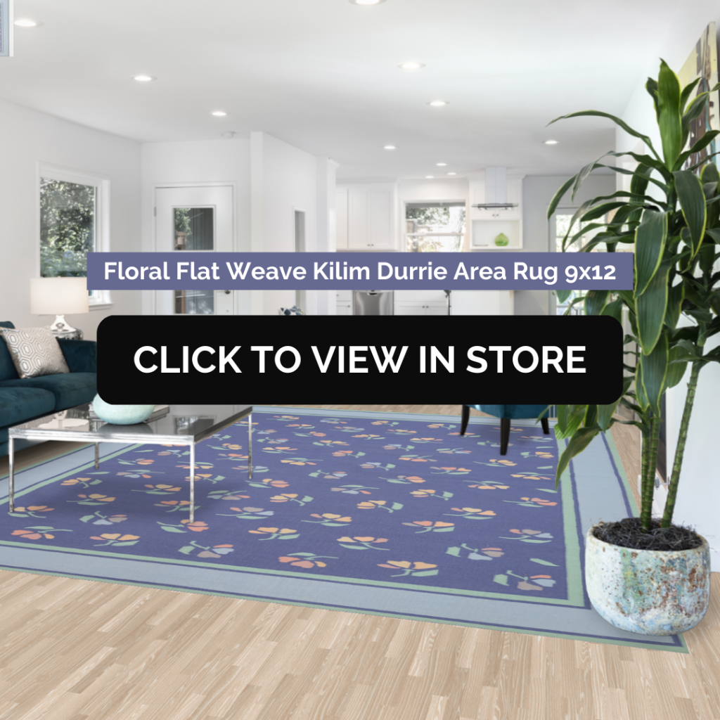 Stylish living room featuring a large floral flat weave Kilim Durrie area rug in blue, measuring 9x12, placed on a light wood floor. The space is accented with modern furniture, indoor plants, and natural lighting through large windows.
