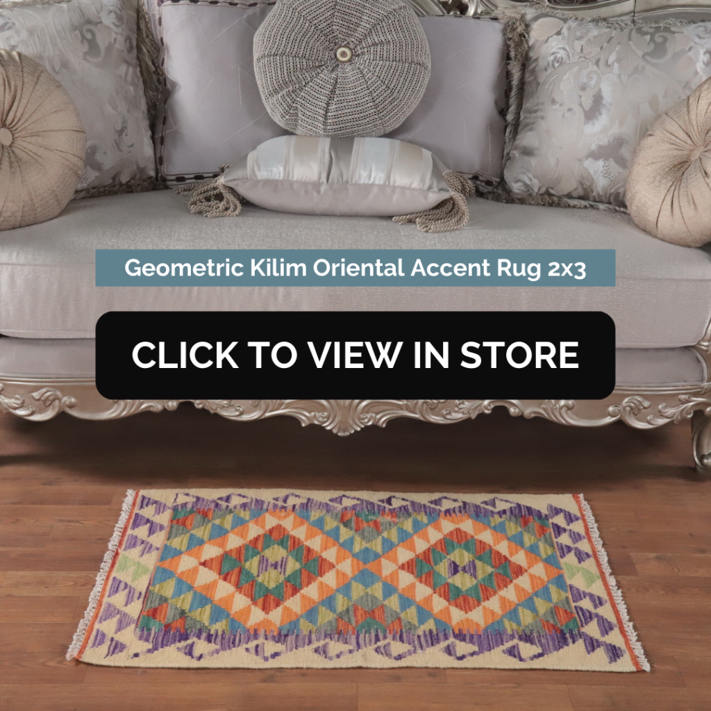 Elegant room featuring a vintage-style geometric Kilim Oriental accent rug in vibrant colors, measuring 2x3, placed on a wooden floor in front of a luxurious silver sofa adorned with plush decorative pillows.