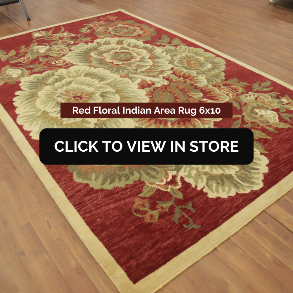 Red Floral Indian Area Rug (6x10) laid on a wooden floor. The rug has a rich red background with large, intricate floral patterns in shades of green, beige, and gold, creating an elegant and traditional look. The image includes text: "Red Floral Indian Area Rug 6x10" and a call-to-action button: "CLICK TO VIEW IN STORE."