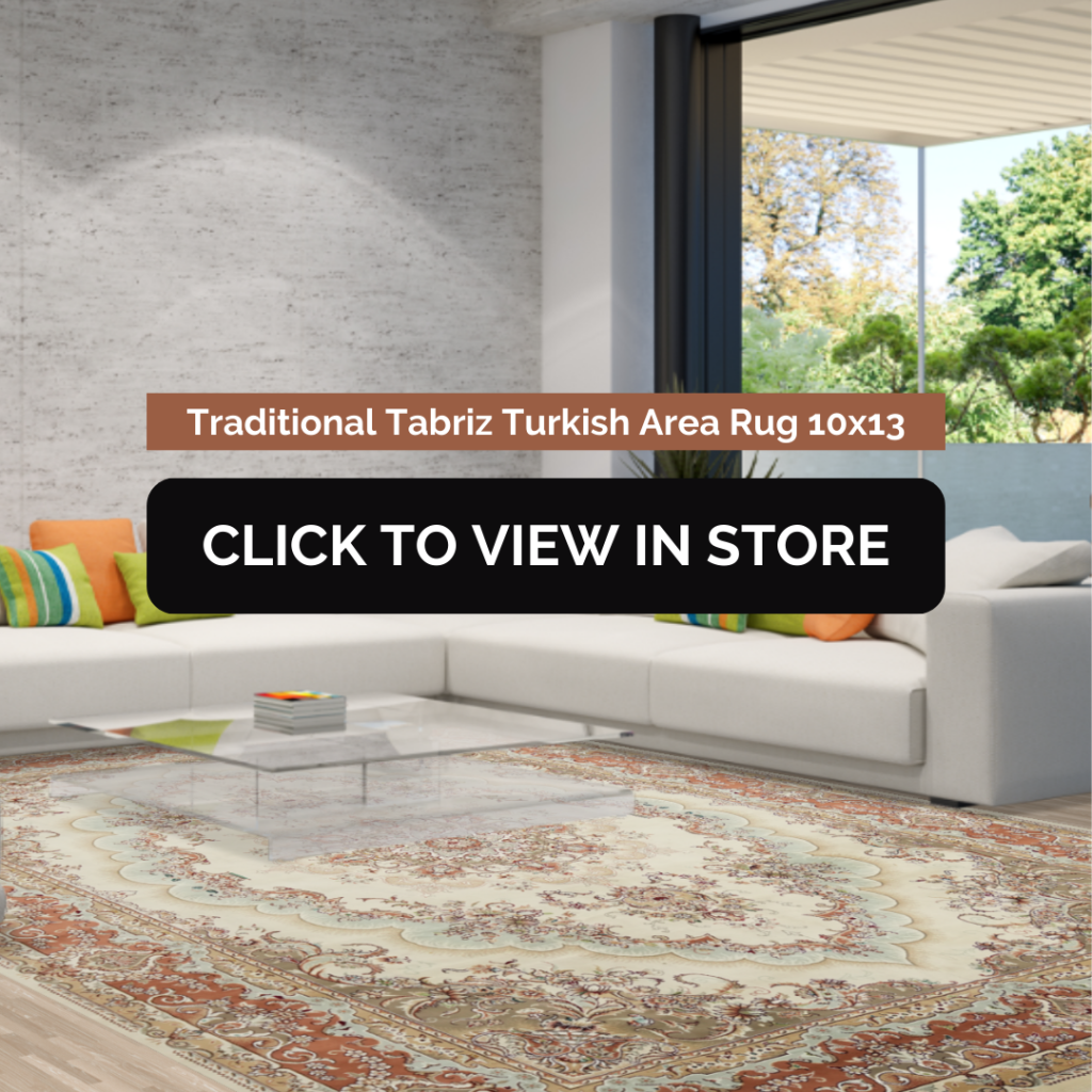 Traditional Tabriz Turkish Area Rug (10x13) displayed in a contemporary living room. The rug has an intricate beige, cream, and rust-colored pattern, adding elegance to the space. It is placed under a modern glass coffee table, surrounded by a large white sectional sofa with colorful accent pillows. The room features a sleek concrete wall and a large sliding glass door leading to an outdoor garden. The image includes text: "Traditional Tabriz Turkish Area Rug 10x13" and a call-to-action button: "CLICK TO VIEW IN STORE."