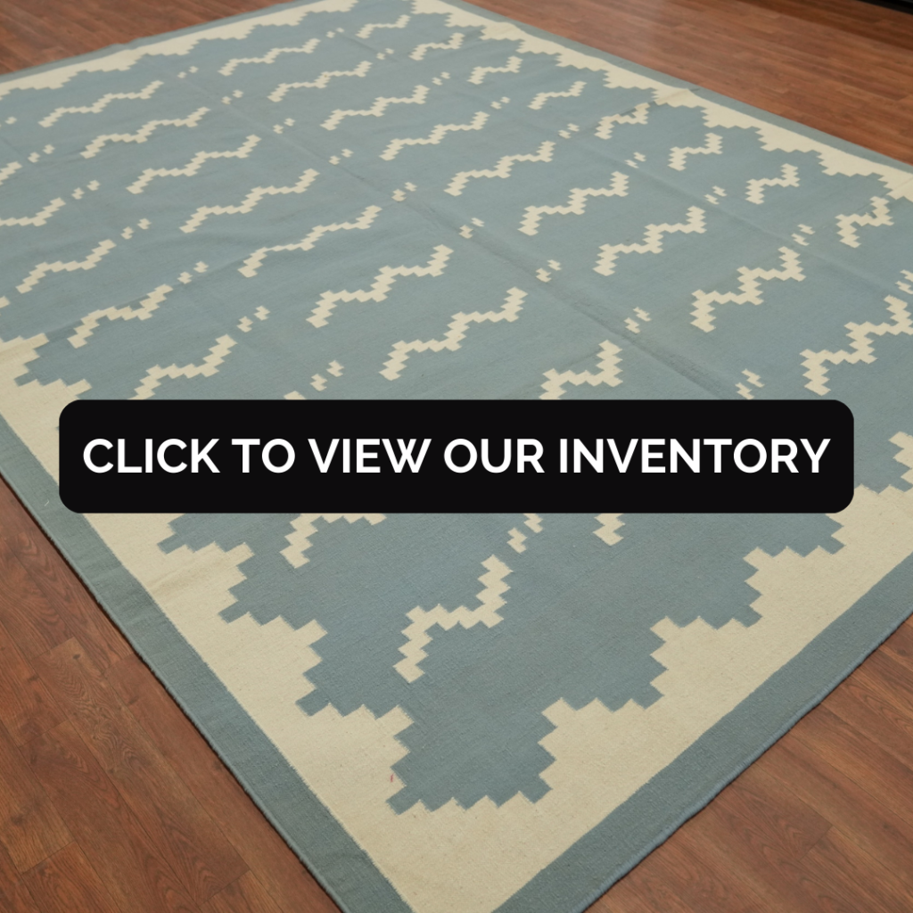 Flat Weave Kilim Durrie Nomad Area Rug 9x12
This flat weave rug features a soft blue background with cream zigzag patterns and is laid out on a wooden floor. The minimalist nomadic design gives it a relaxed yet refined appeal.
