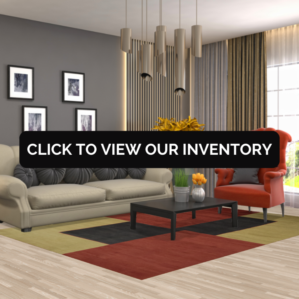 A contemporary living room with a beige sofa, red accent chair, and a bold rug in red, green, and black blocks beneath a black coffee table.