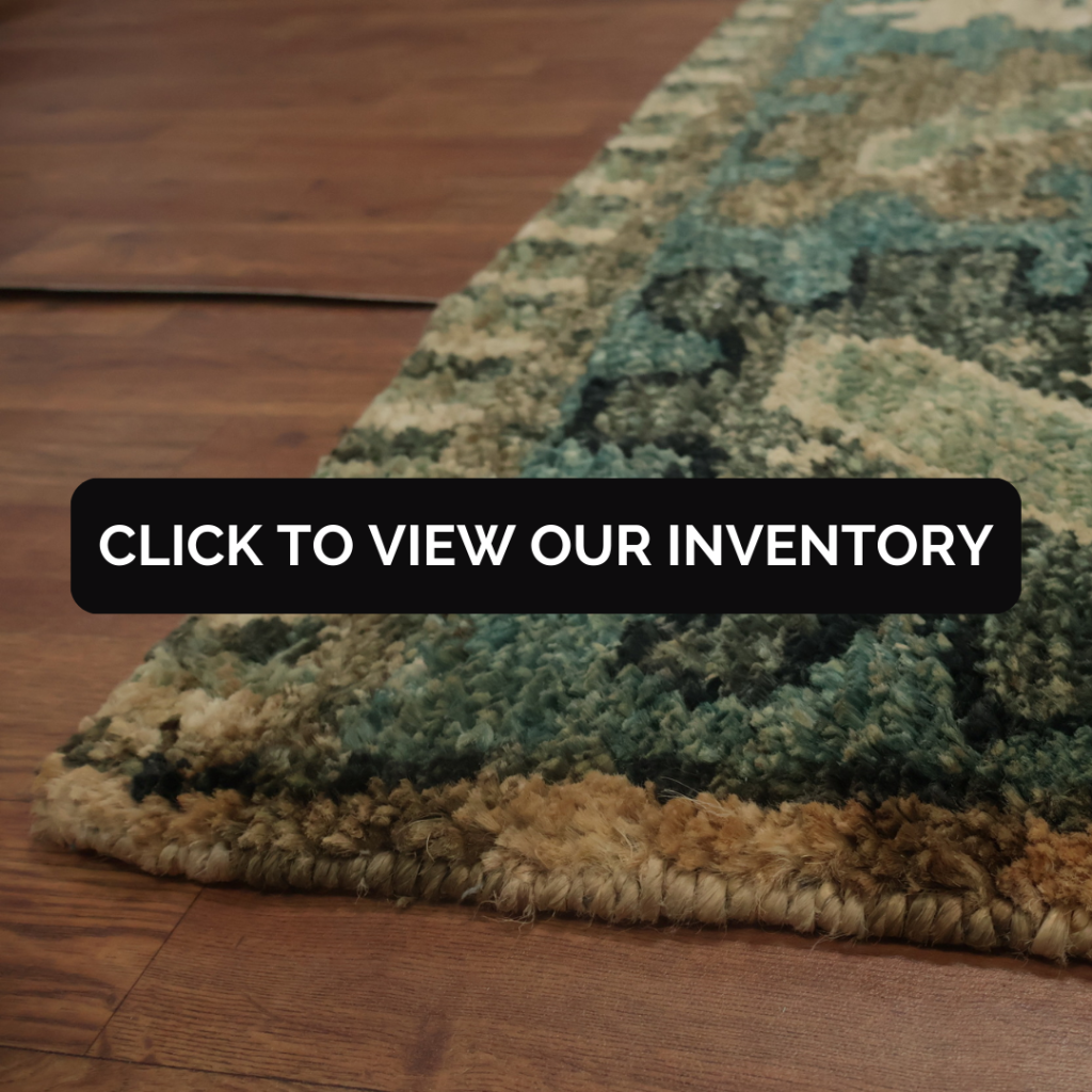 A close-up view of a thick, plush rug with green, brown, and cream tones showing its detailed texture.