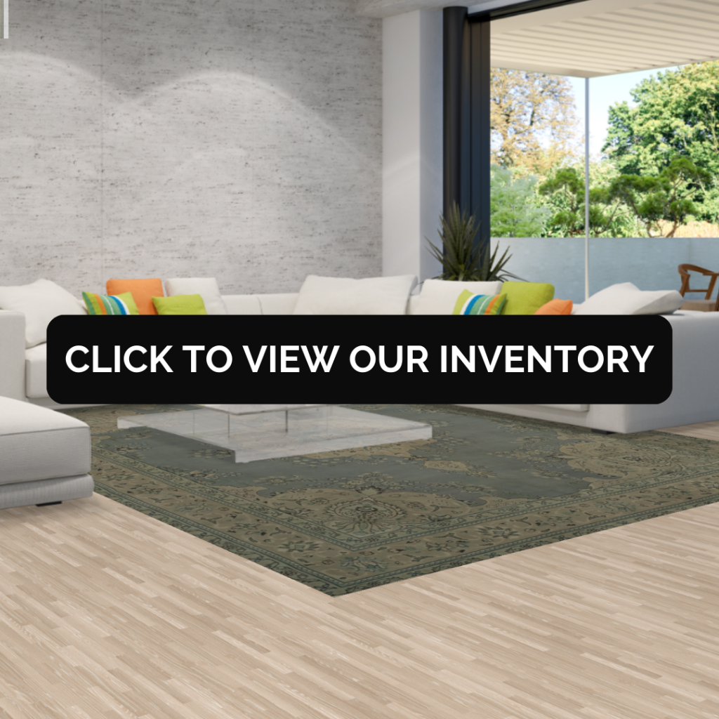 A large modern living room with a sectional white sofa and a muted green patterned rug under a glass coffee table.