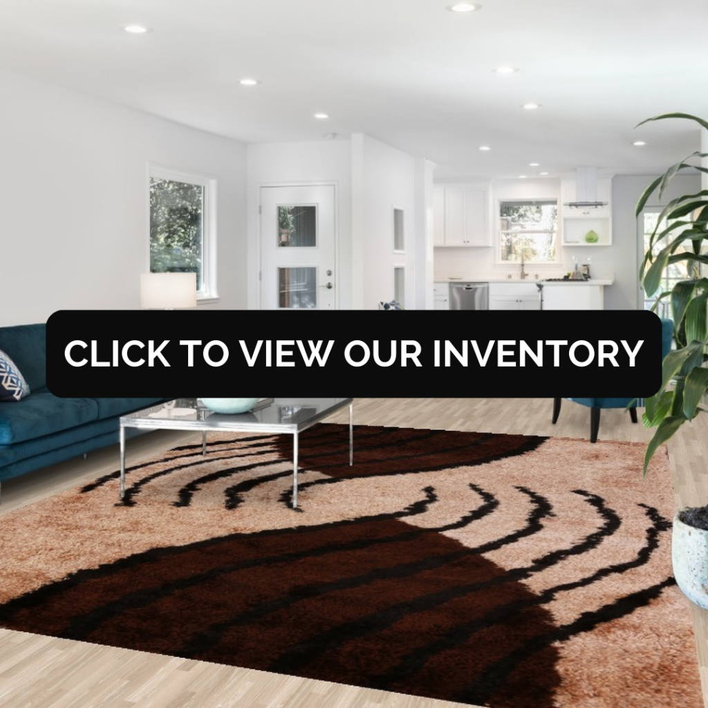 A contemporary living room with a brown and black patterned shag rug, paired with a teal sofa and glass coffee table, overlaid with a black banner that reads “Click to View Our Inventory.”