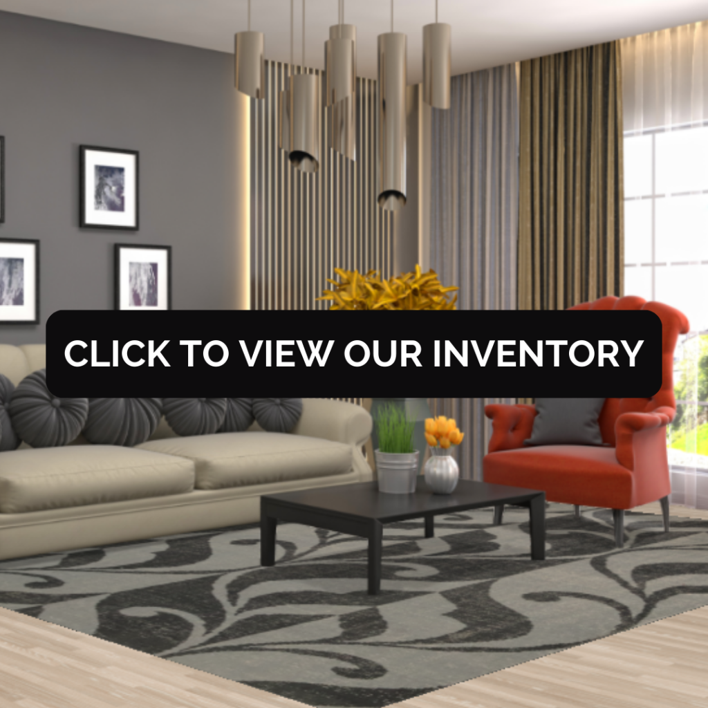 A stylish living room with a beige sofa, black patterned rug, and a bold orange accent chair. The space features tall curtains, framed wall art, and a modern chandelier. Text overlay reads “Click to view our inventory.”