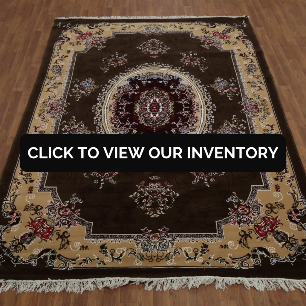 A richly detailed Persian-style rug with a dark brown base, ornate floral medallion in the center, and a beige border. The rug is displayed flat on a wooden floor. Text overlay reads “Click to view our inventory.”