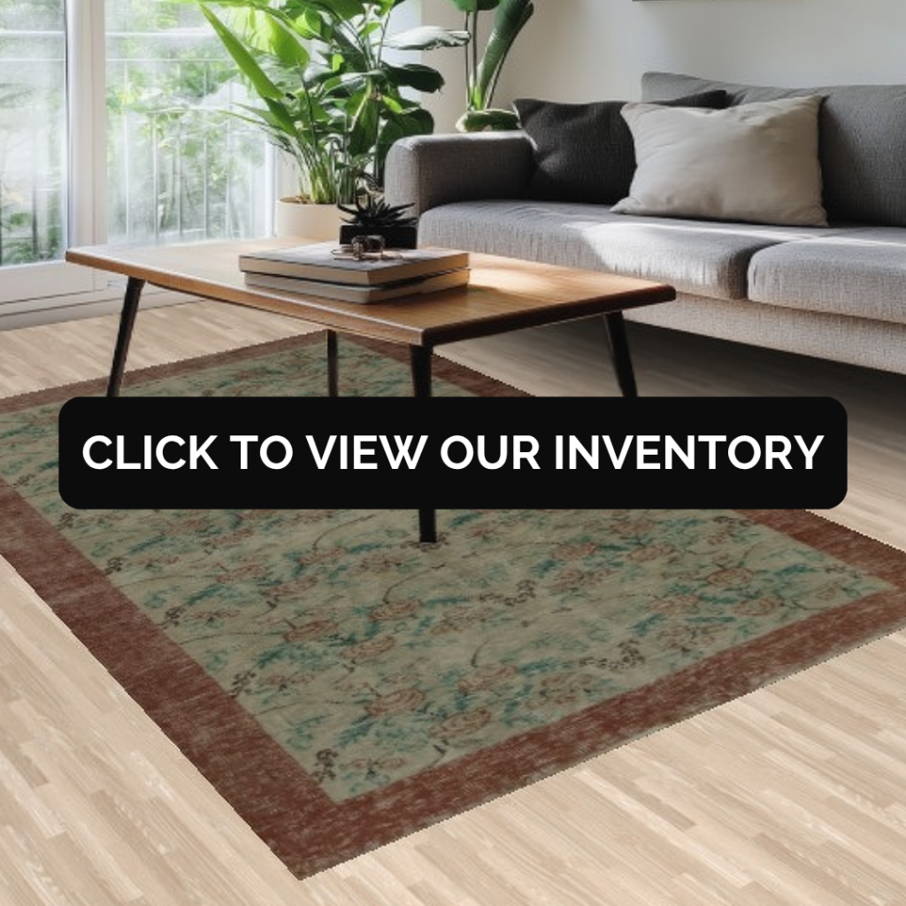 A bright, plant-filled living space with a gray sofa and a muted green rug bordered in deep brown, featuring a soft floral pattern. Text overlay encourages viewers to shop the collection.