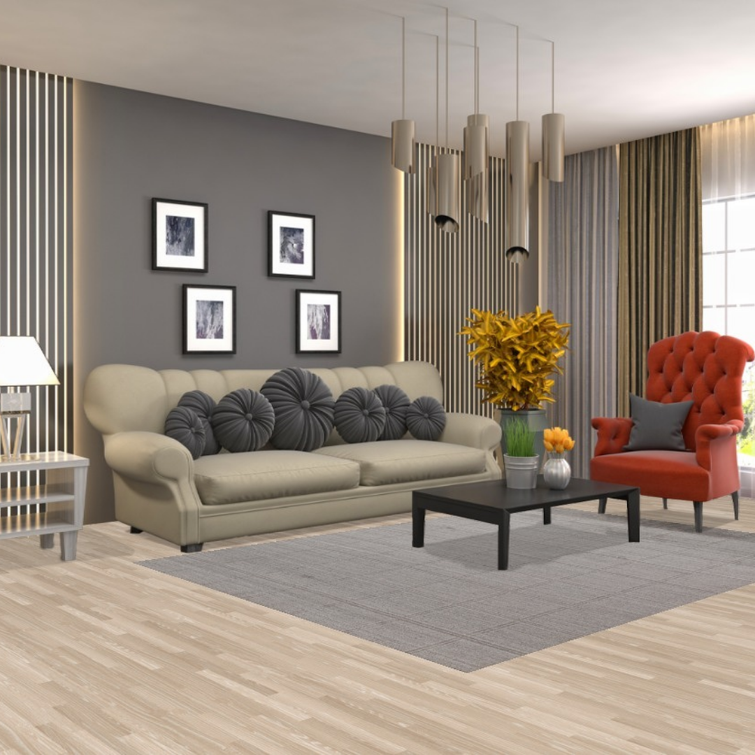 A cream loveseat with round decorative pillows is staged in front of shelves filled with rolled rugs in a warehouse setting. A golden-yellow rug with a deep brown border lies on the hardwood floor beneath it. A black button displaying “CLICK TO VIEW OUR INVENTORY” overlays the lower portion of the image.