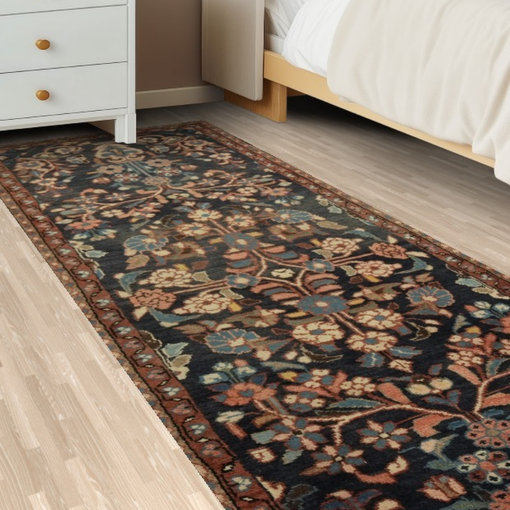 “Floral patterned runner rug beside a bed and nightstand on a light wood bedroom floor.”