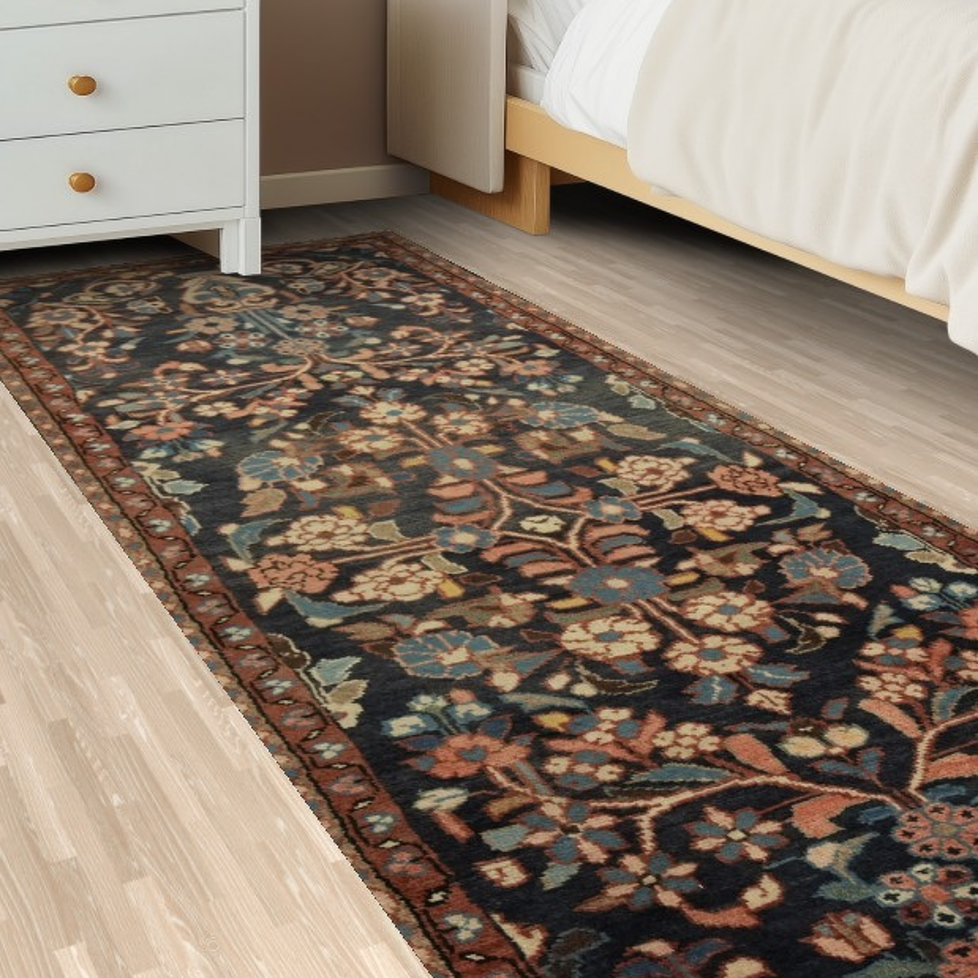 “Floral patterned runner rug beside a bed and nightstand on a light wood bedroom floor.”