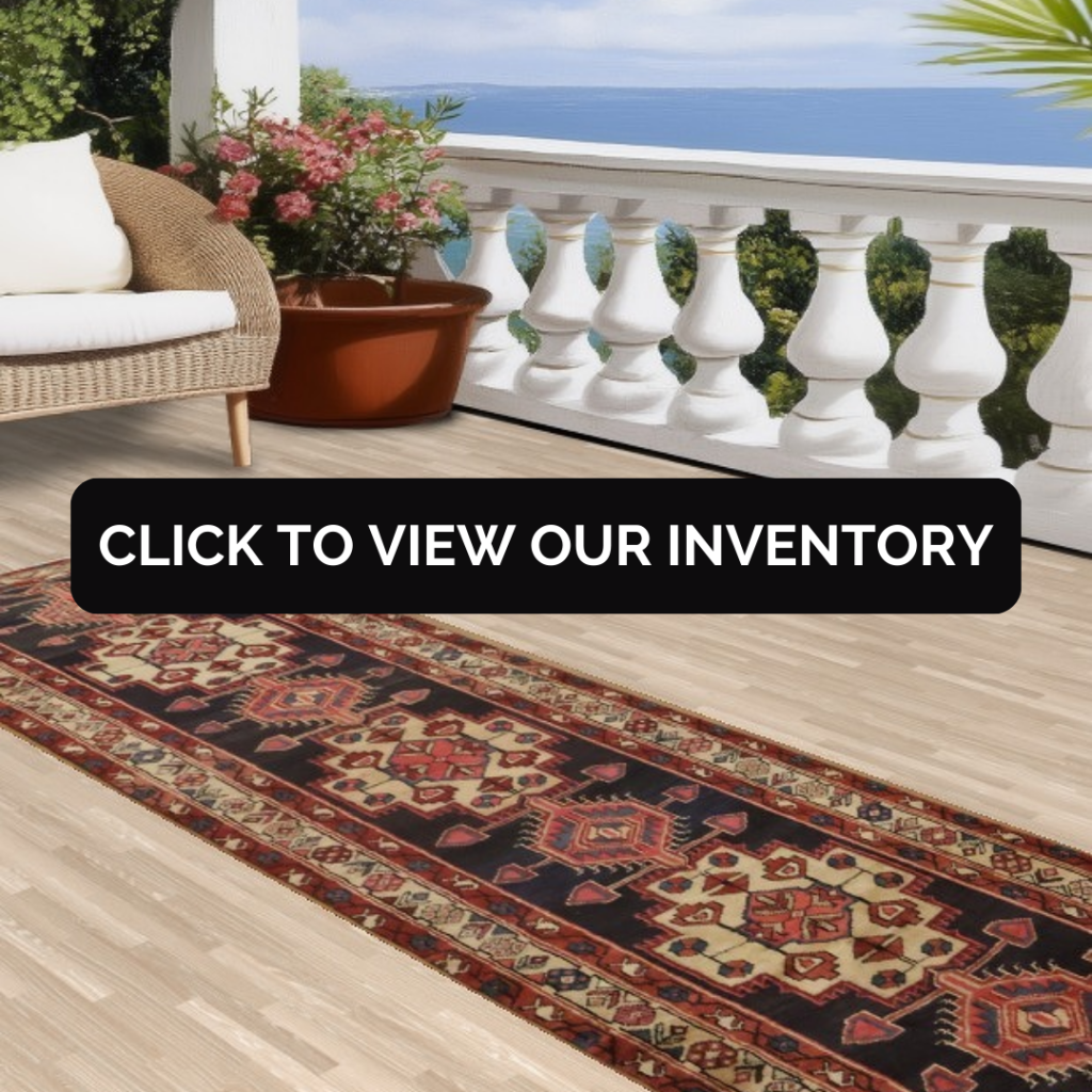 “Outdoor balcony with ocean view, wicker chair, potted flowers, and a patterned runner rug on a light wood floor. Black button reads ‘Click to View Our Inventory.’”