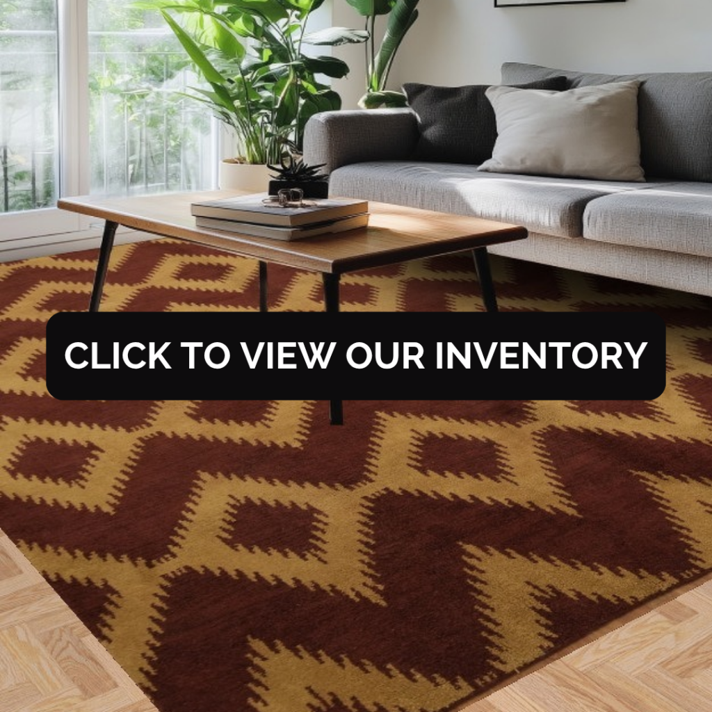 A modern living room with a gray sofa and wooden coffee table, featuring a geometric rug with bold brown and tan zigzag patterns. A black banner across the center reads “Click to view our inventory.”