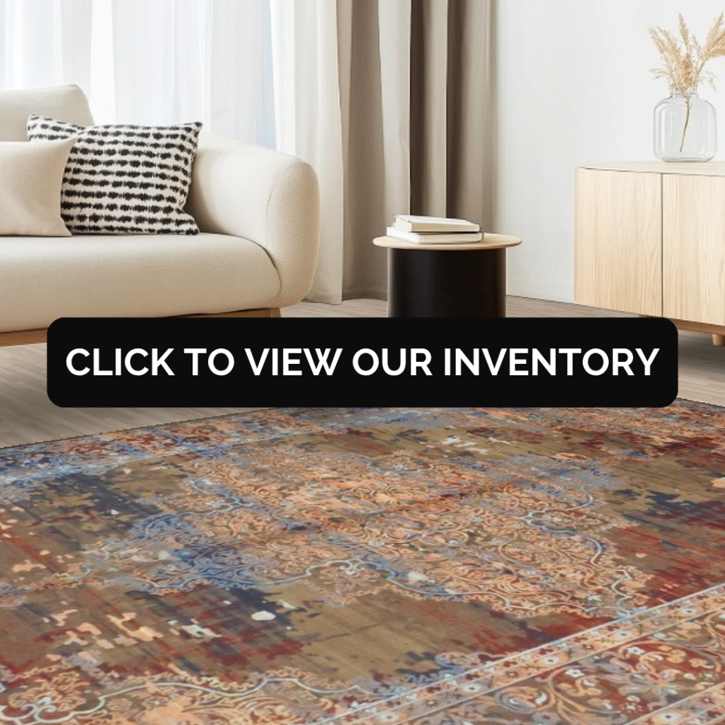 A modern living room with a cream sofa, black side table, and light wood cabinet, featuring a distressed vintage-style rug in warm brown and blue tones. A black banner across the center reads “Click to view our inventory.”