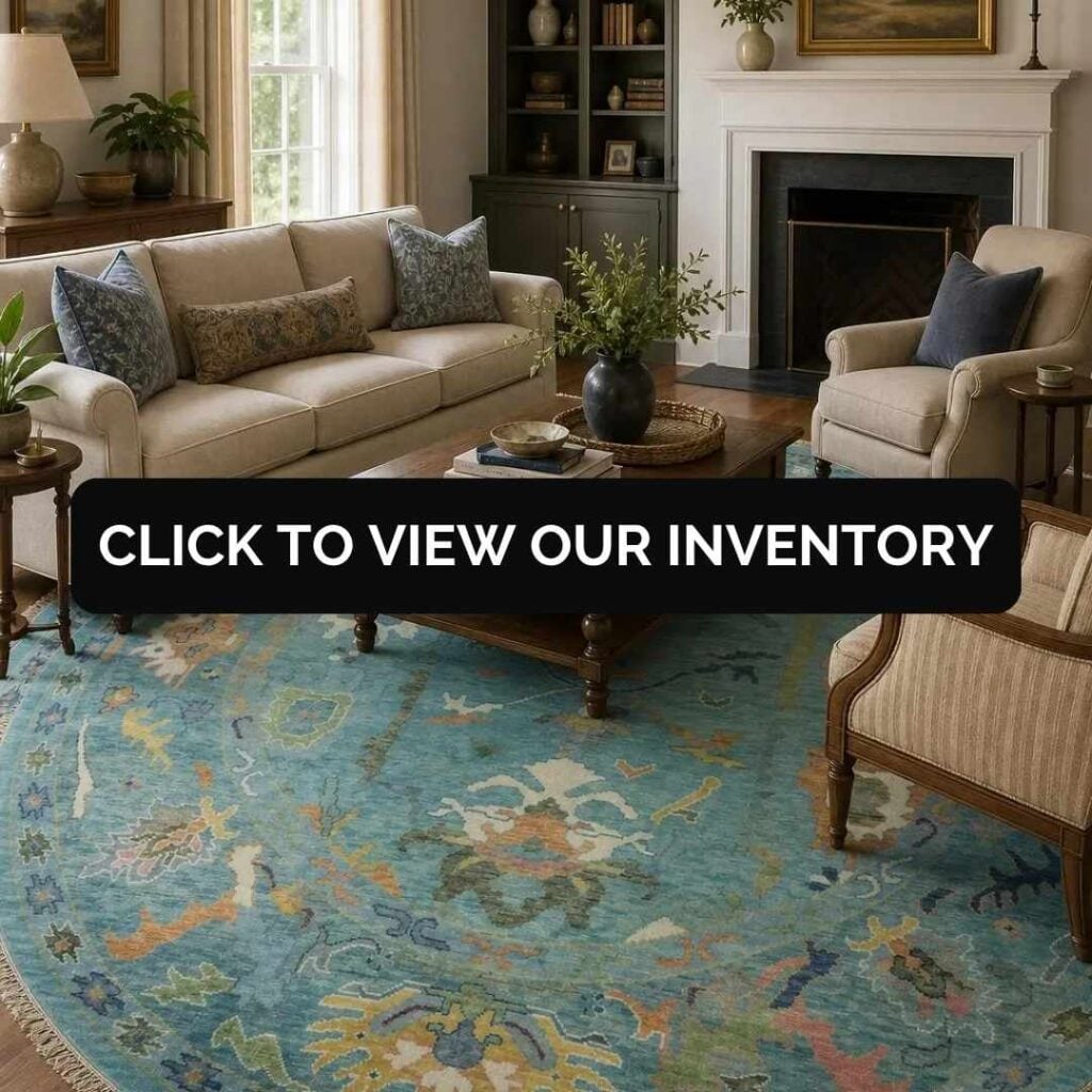 Elegant living room with a large blue traditional area rug, neutral furniture, fireplace, and "Click to View Our Inventory" banner.