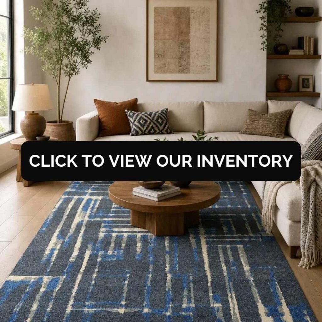 Modern living room with a blue geometric area rug, neutral sectional sofa, wood coffee table, and a "Click to View Our Inventory" banner.
